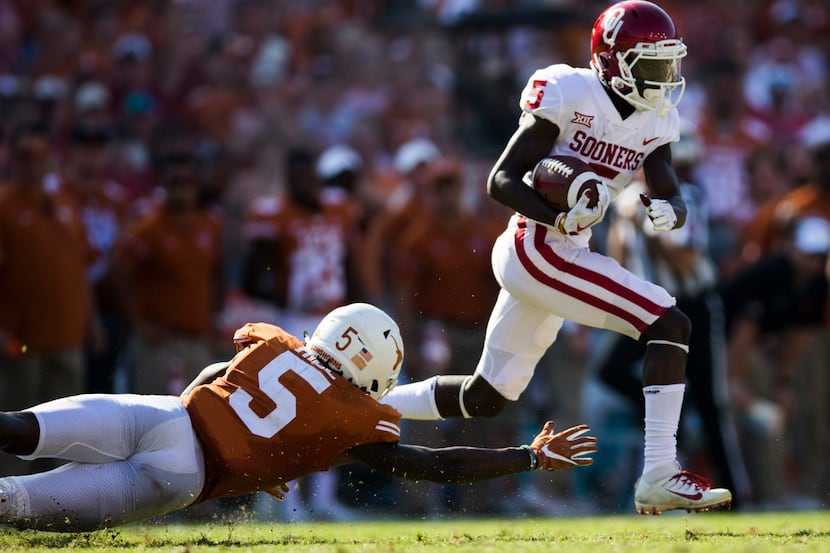 Oklahoma Sooners wide receiver Marquise Brown (5) is tackled by Texas Longhorns defensive...