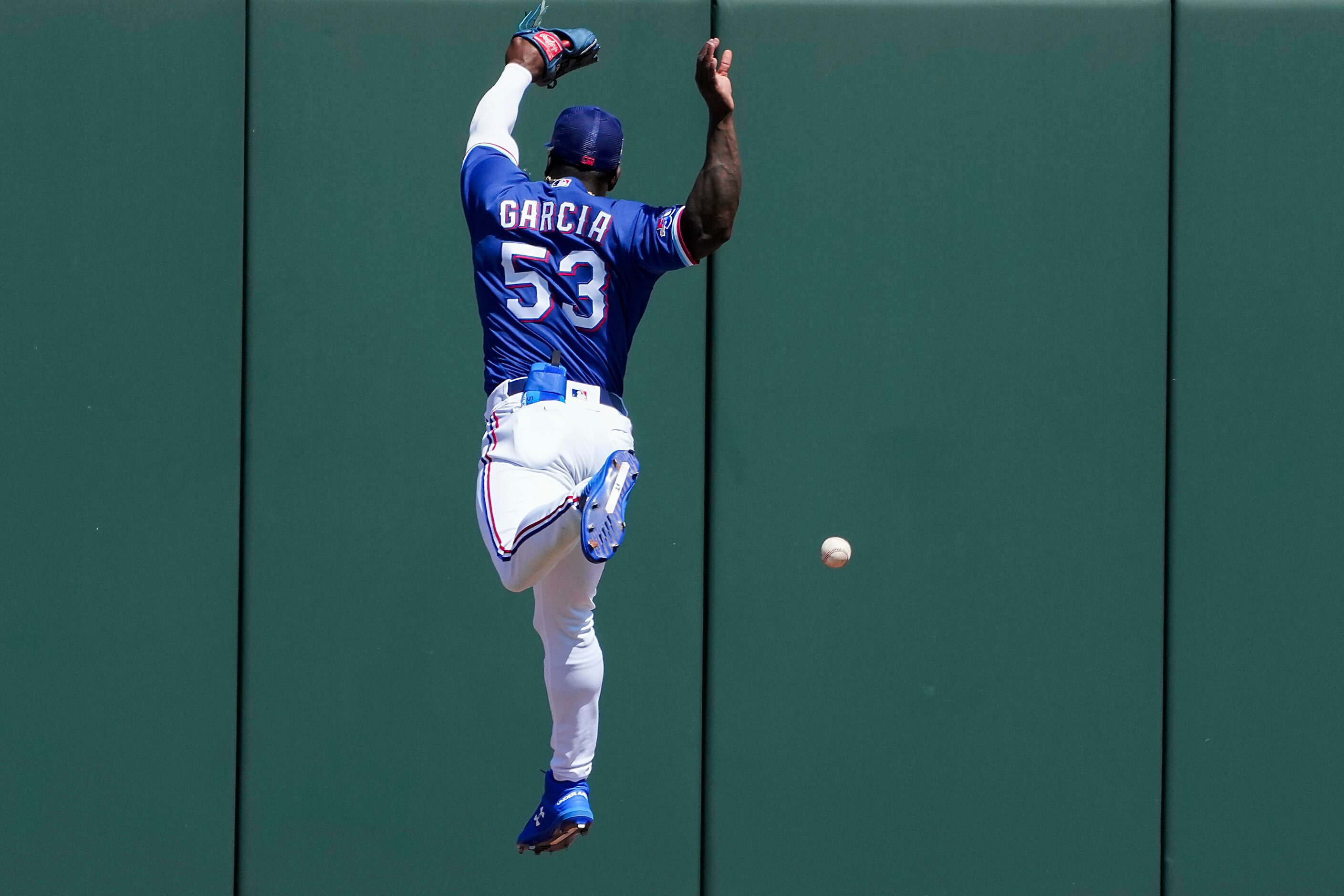 Texas Rangers outfielder Adolis García can’t get to a triple off the bat of Los Angeles...