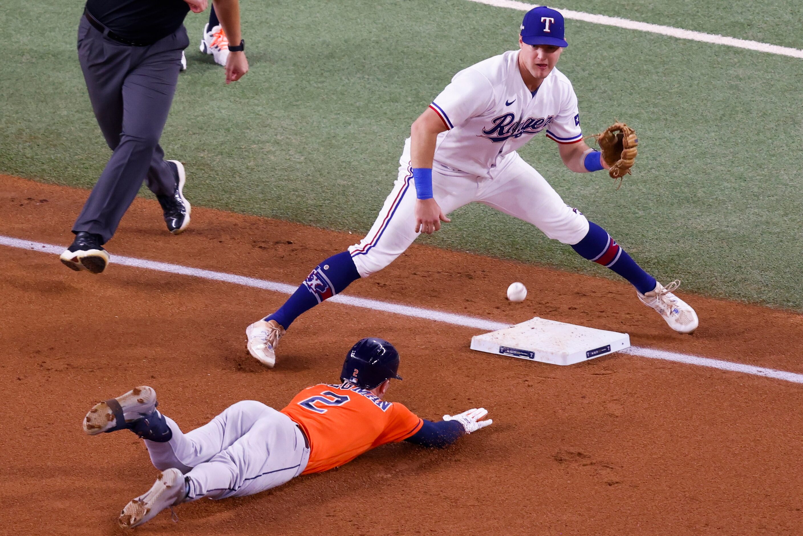 Houston Astros third baseman Alex Bregman (2) reaches third base on a triple as Texas...