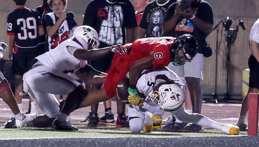 Coppell running back O'Marion Mbakwe (6) fumbles the ball short of the goal line as...