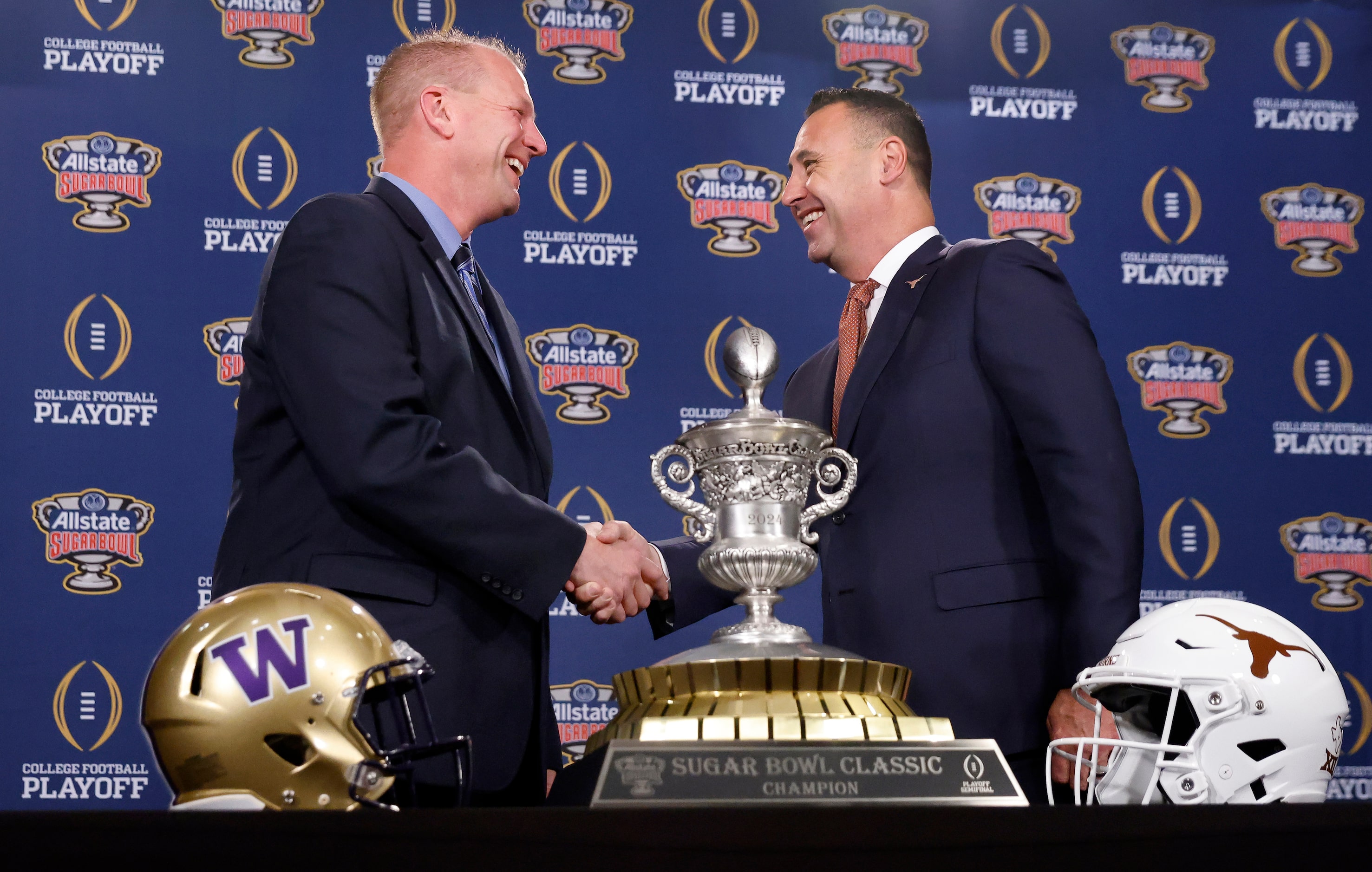 Washington head coach Kalen DeBoer (left) and Texas head coach Steve Sarkisian shake hands...