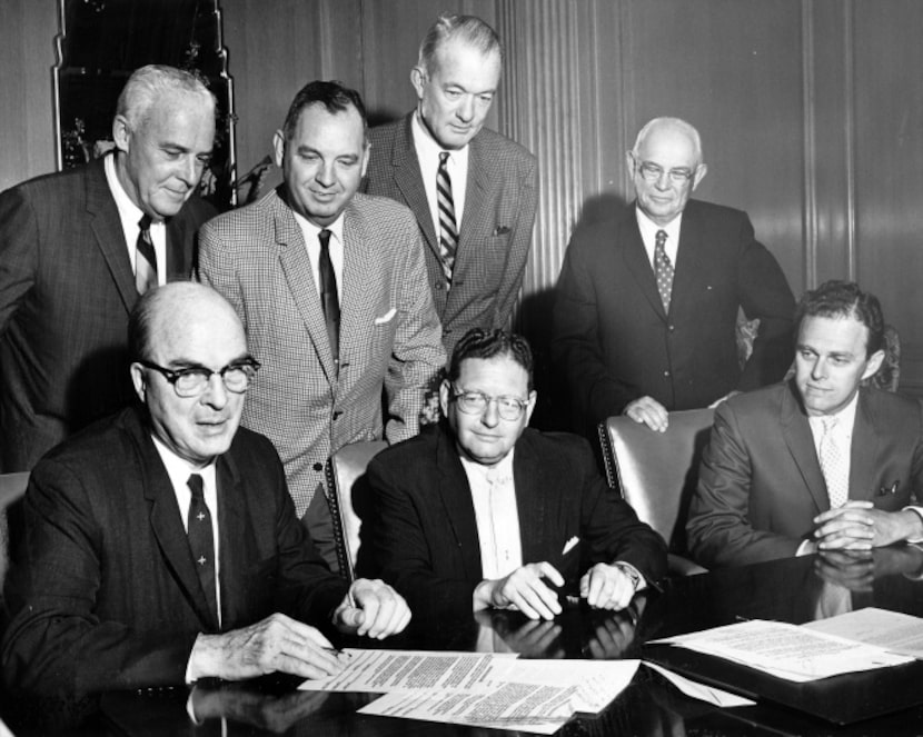 Dallas Mayor Erik Jonsson (seated left), accompanied by other area dignitaries, prepares to...