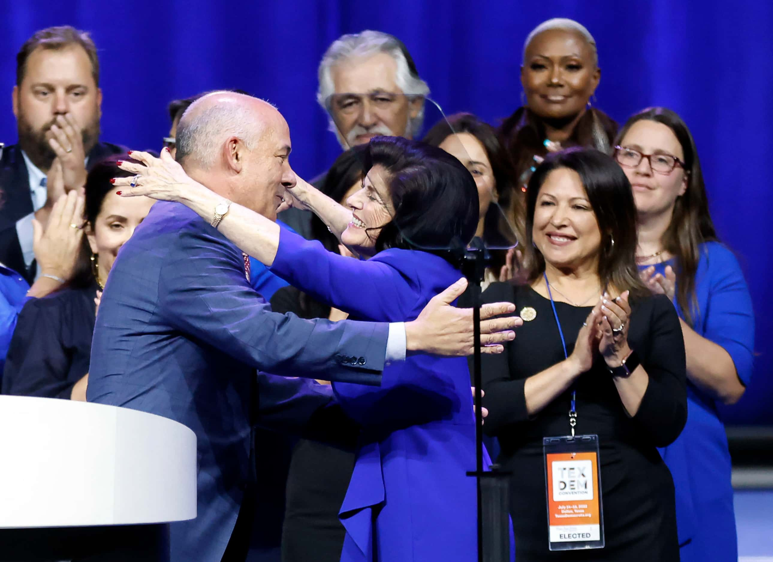 Texas House Democratic Caucus Chair Chris Turner (left) receives a hug from Luci Baines...