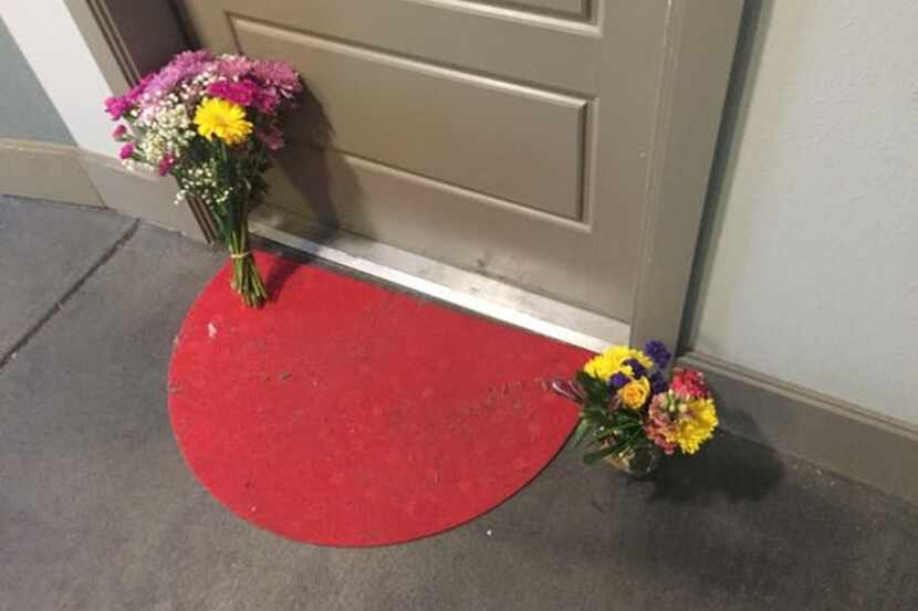 Flowers decorate Botham Jean's front door at the South Side Flats apartments in Dallas'...