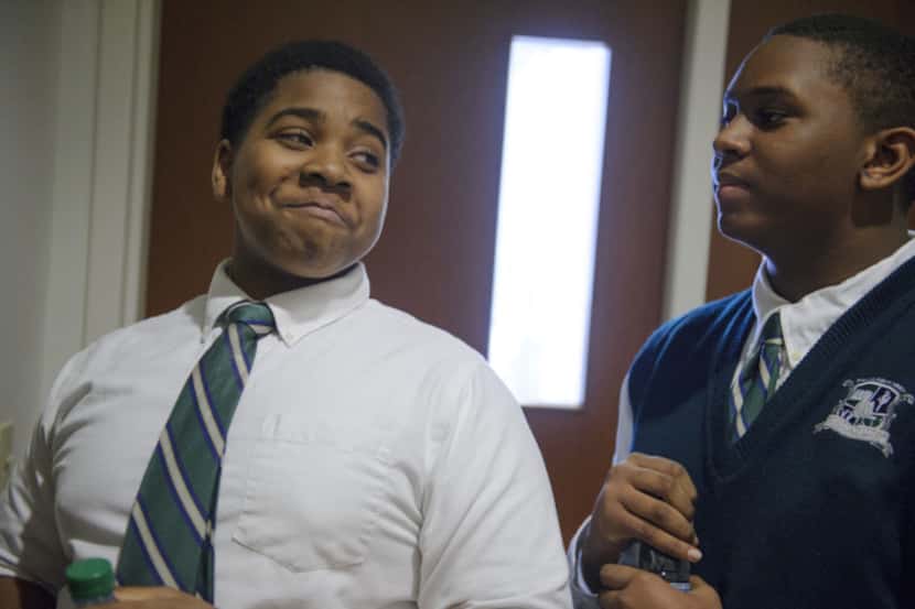 Clarence Smith (left) smiles at teammate Jacob Crockett from Young Men's Leadership Academy...