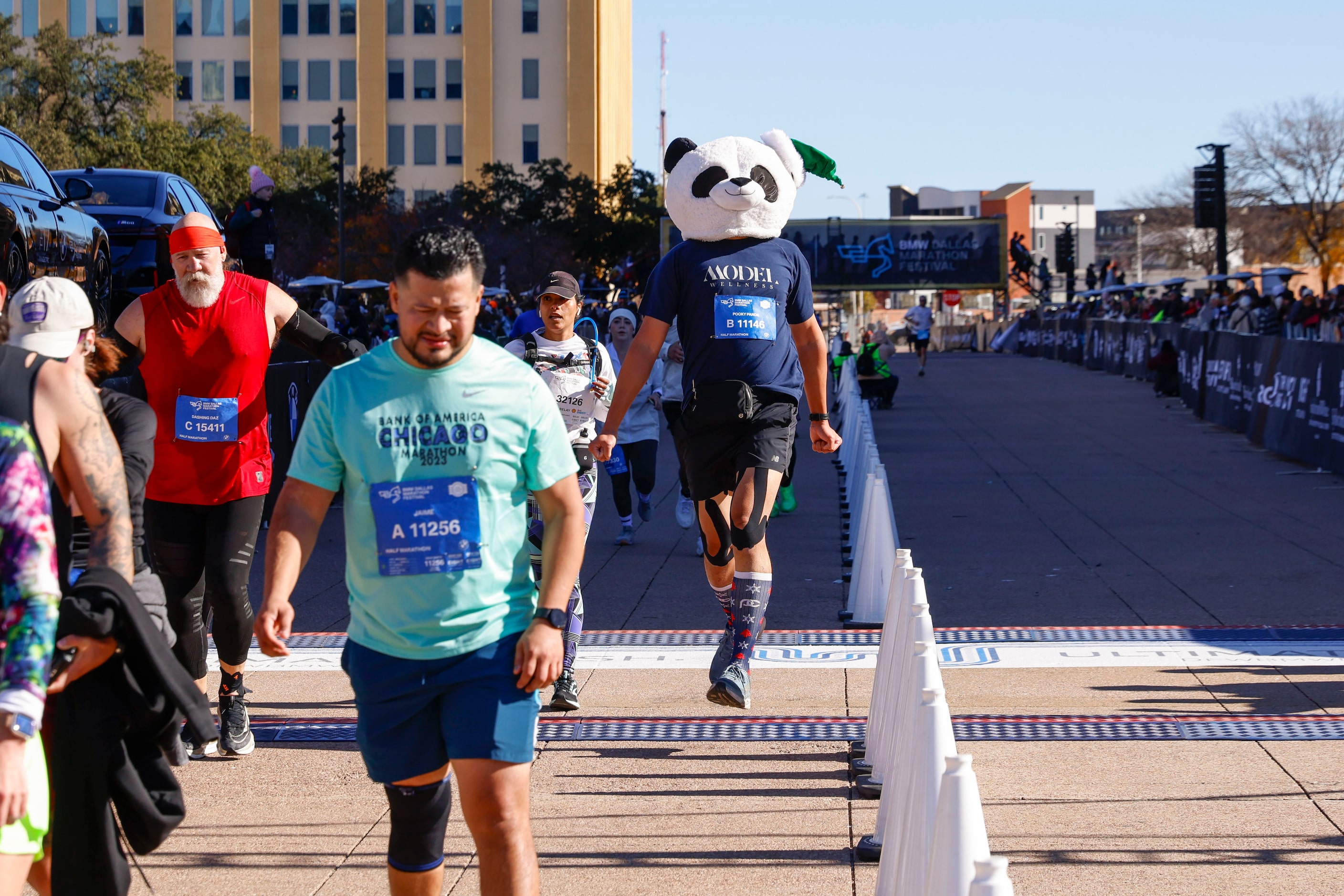 Half marathon runner Dr. Mark Hsu wearing a panda head gear reaches the finishing line...