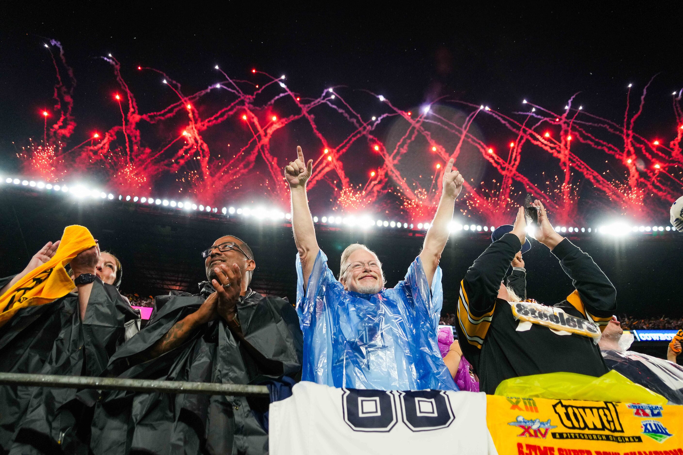 Fans cheer as fireworks explode at the end of the national anthem before an NFL football...