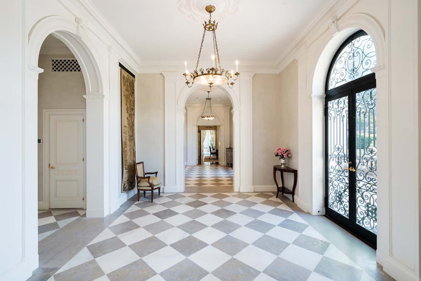 Original light fixtures and floors adorn the front entry halls of the historic Crespi Estate.