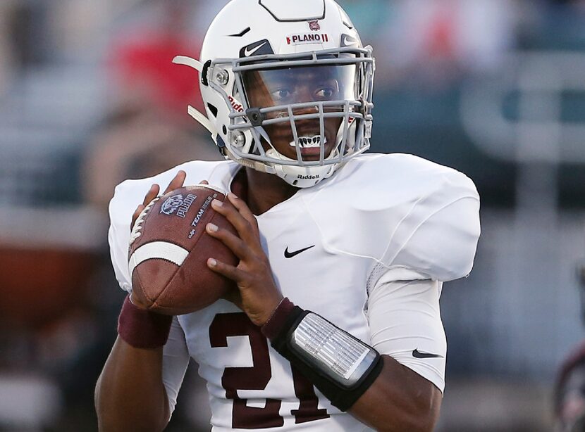 TXHSFB Plano senior quarterback Jonathan Taylor (21) looks to pass during the first half of...