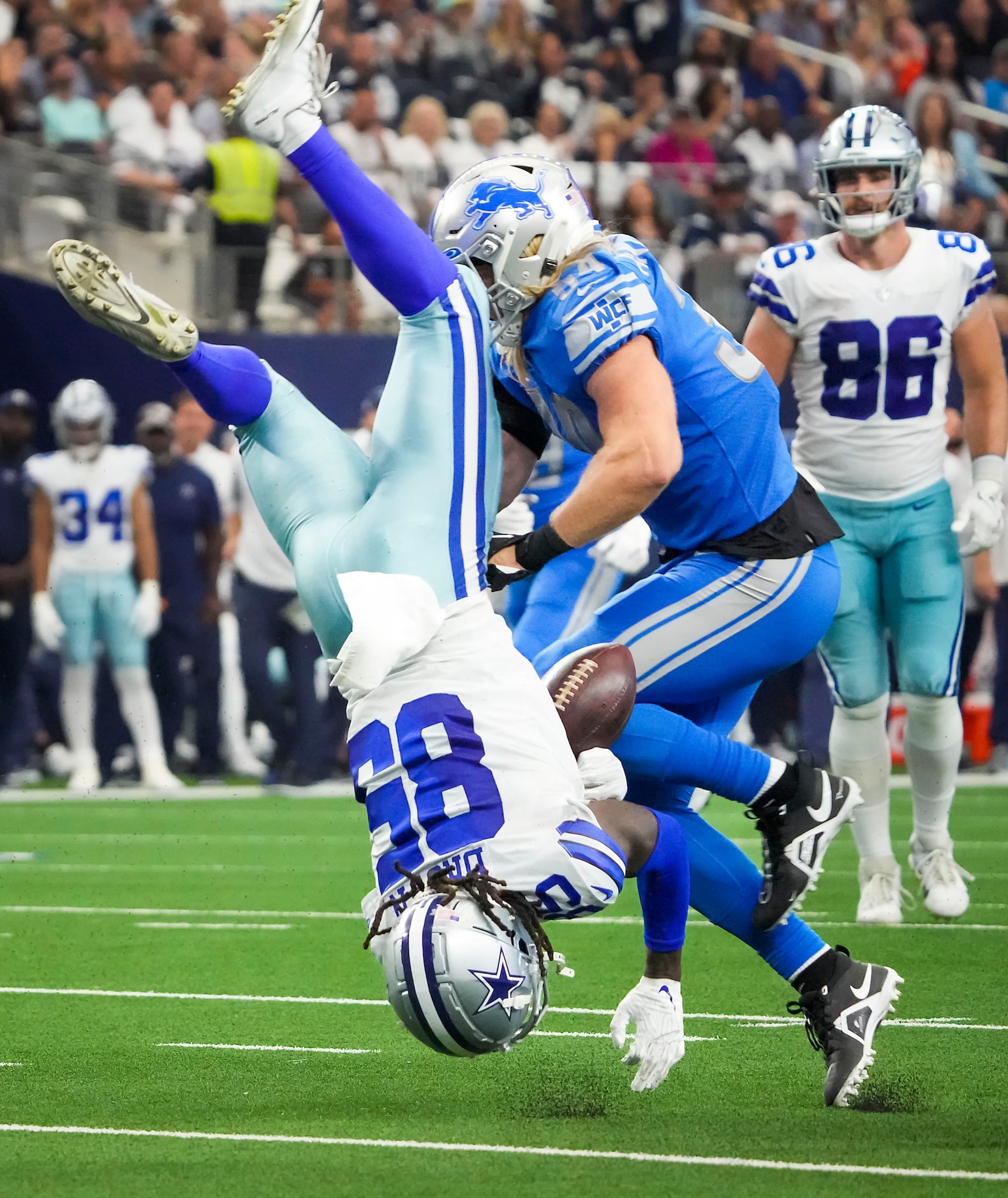 Dallas Cowboys wide receiver Noah Brown (85) fumbles as he is flipped upside down while...