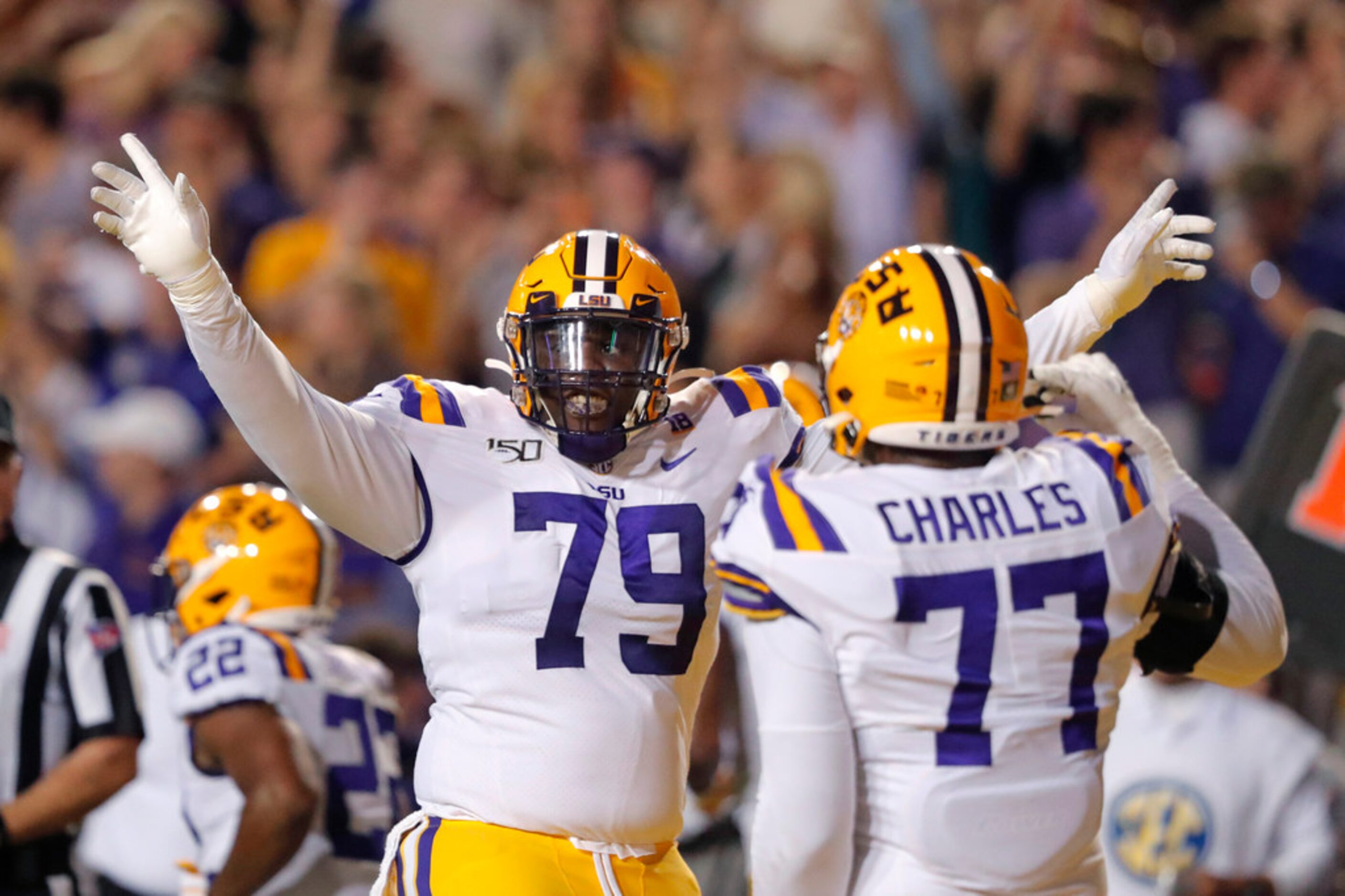 LSU center Lloyd Cushenberry III (79) and offensive tackle Saahdiq Charles (77) celebrate an...