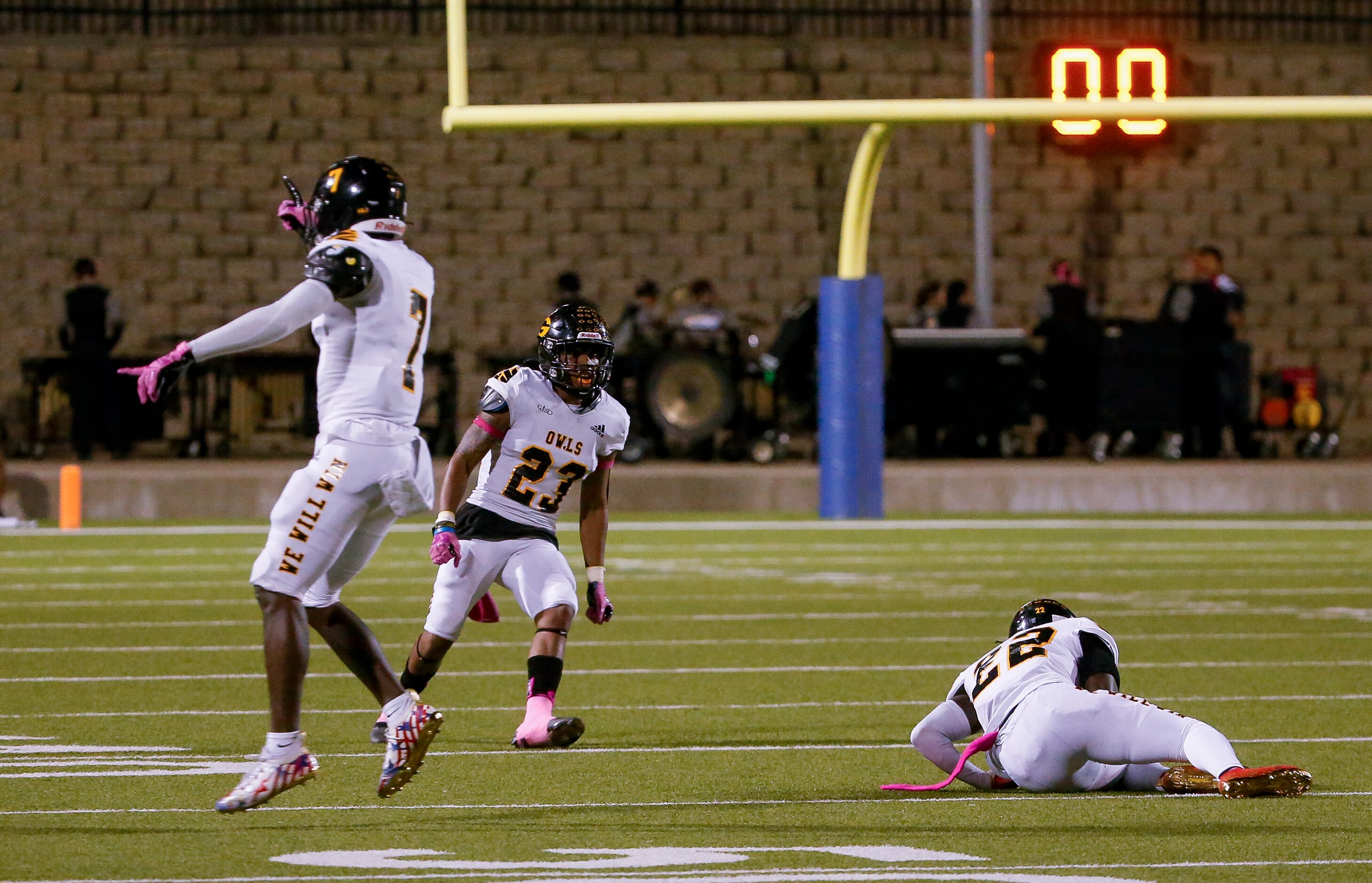 Garland players celebrate Christian Cooper’s (22) interceptions during the second quarter of...