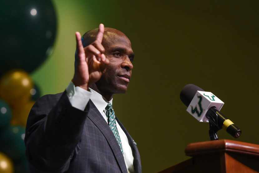 South Florida's new NCAA college football head coach Charlie Strong gestures during a press...