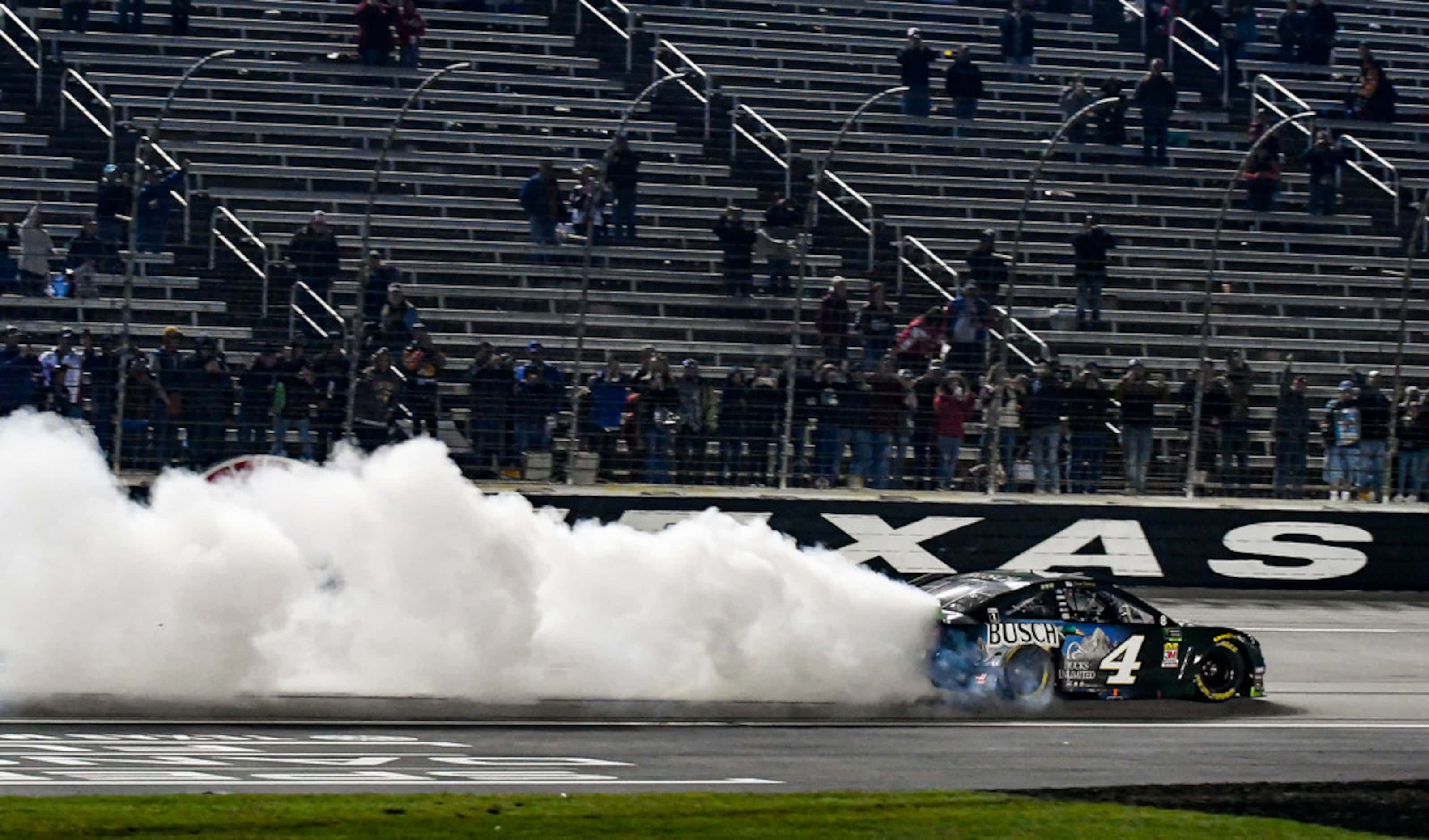 Kevin Harvick (4) celebrates winning a NASCAR Cup Series auto race with a burnout at Texas...
