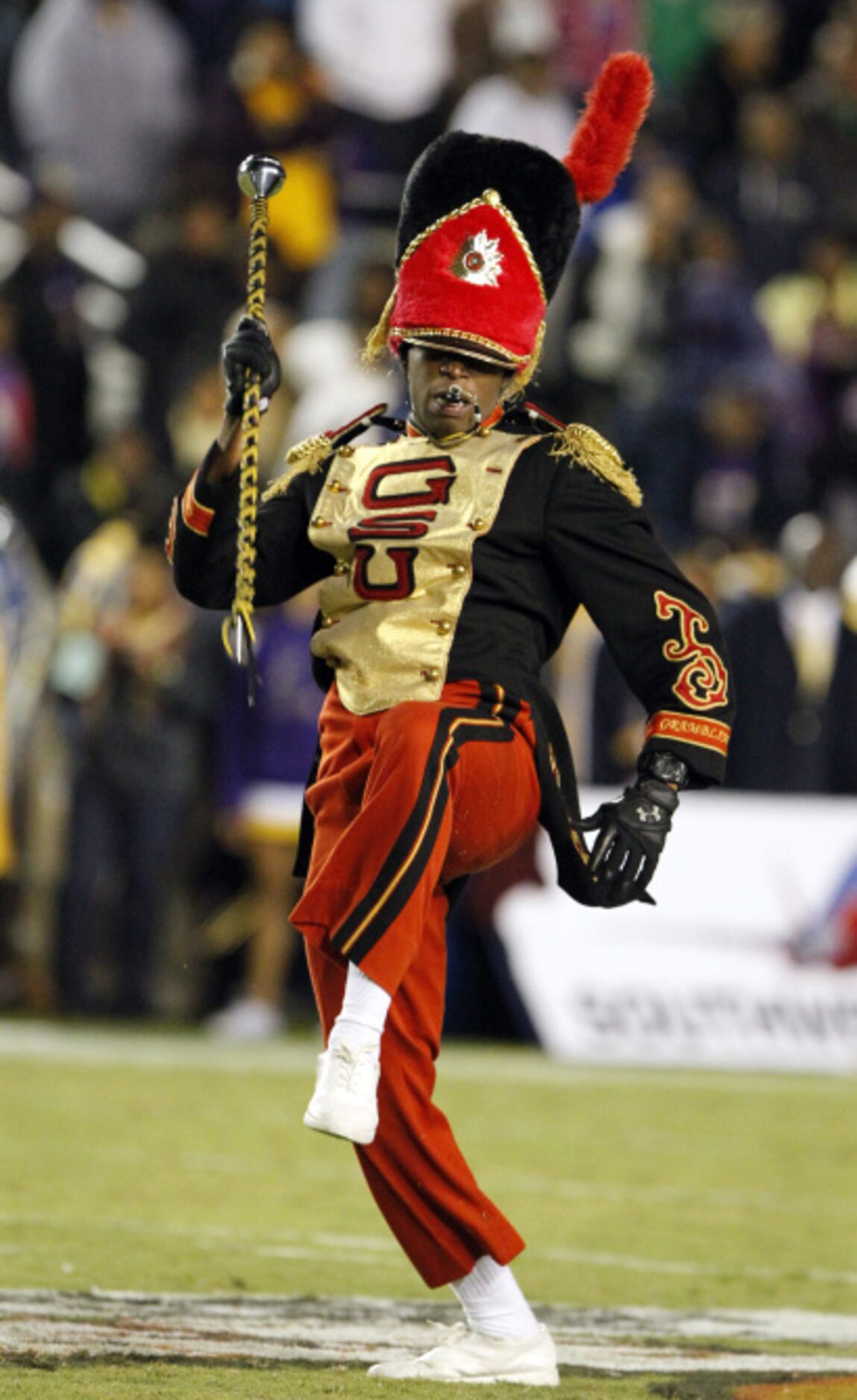 A Grambling drum major high struts during the halftime show of a NCAA football game between...