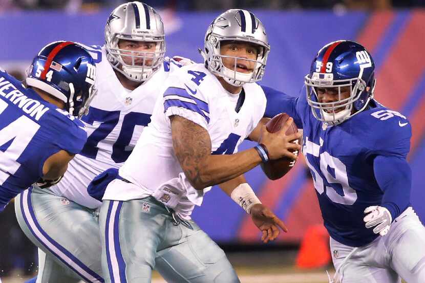 Dallas Cowboys quarterback Dak Prescott (4) looks to avoid the pressure in the pocket during...