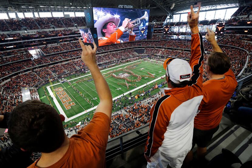 Texas Longhorns fans cheer as the marching band performs before the Big 12 Championship at...