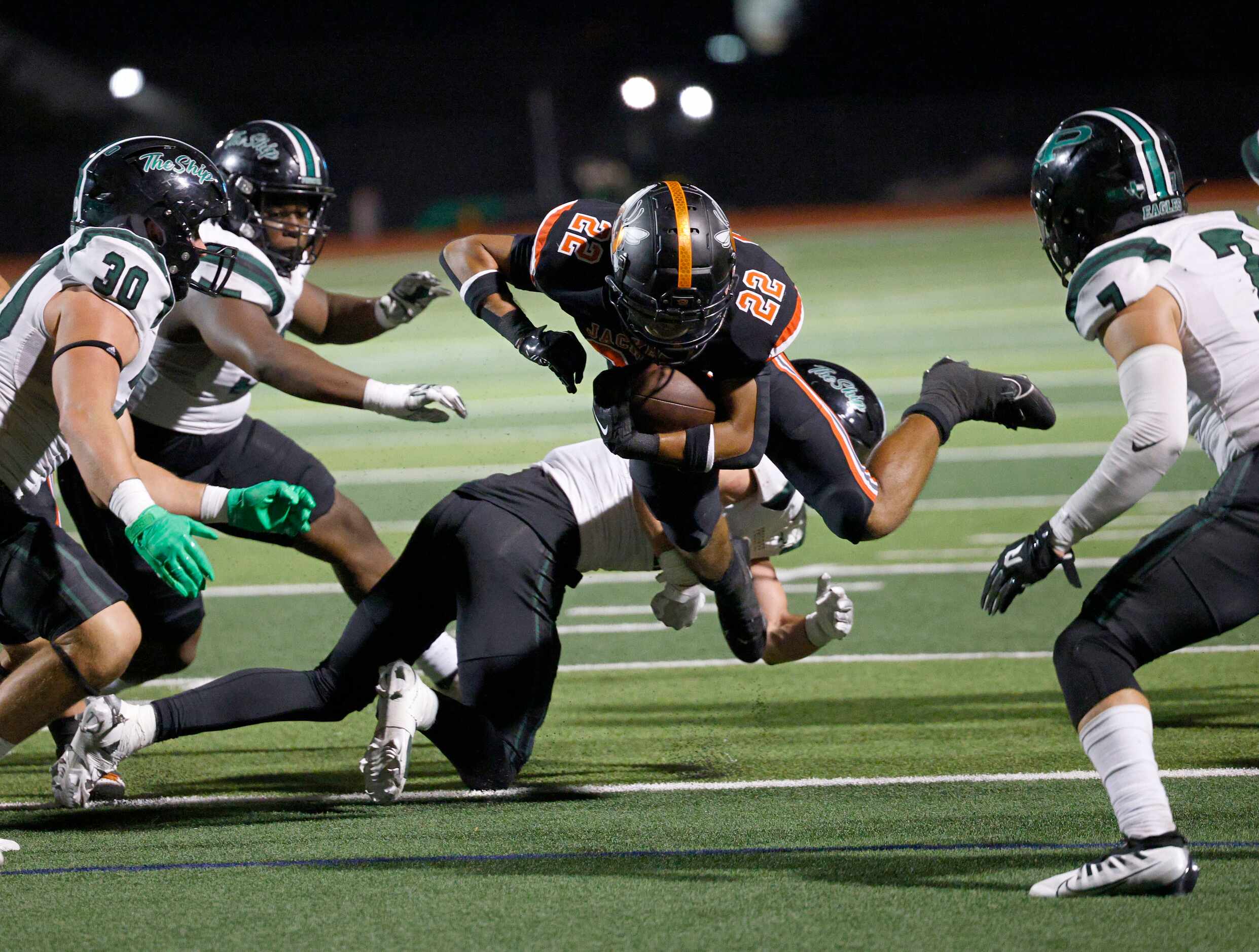 Prosper’s defense players go to stop Rockwall's Parker Williams (22) during the first half...