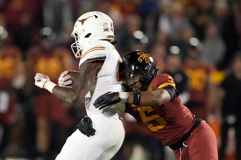 Iowa State defensive back Myles Purchase (5) tackles Texas running back CJ Baxter (4) during...