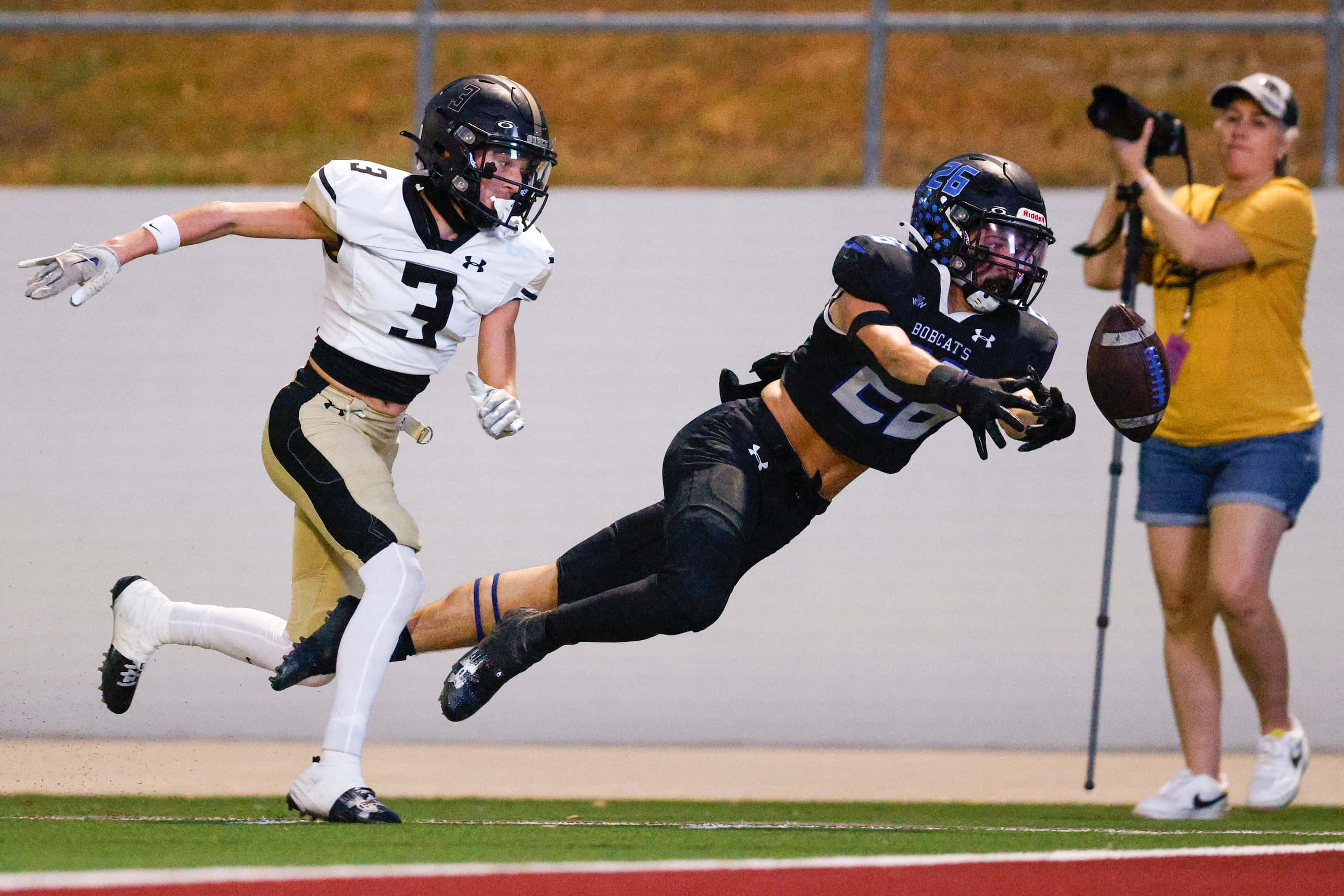 Trophy Club Byron Nelson running back Tucker James (26) loses control of the football after...