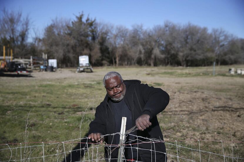 
Mark Carter helped take down an old fence Wednesday on an 18-acre plot of land donated to...