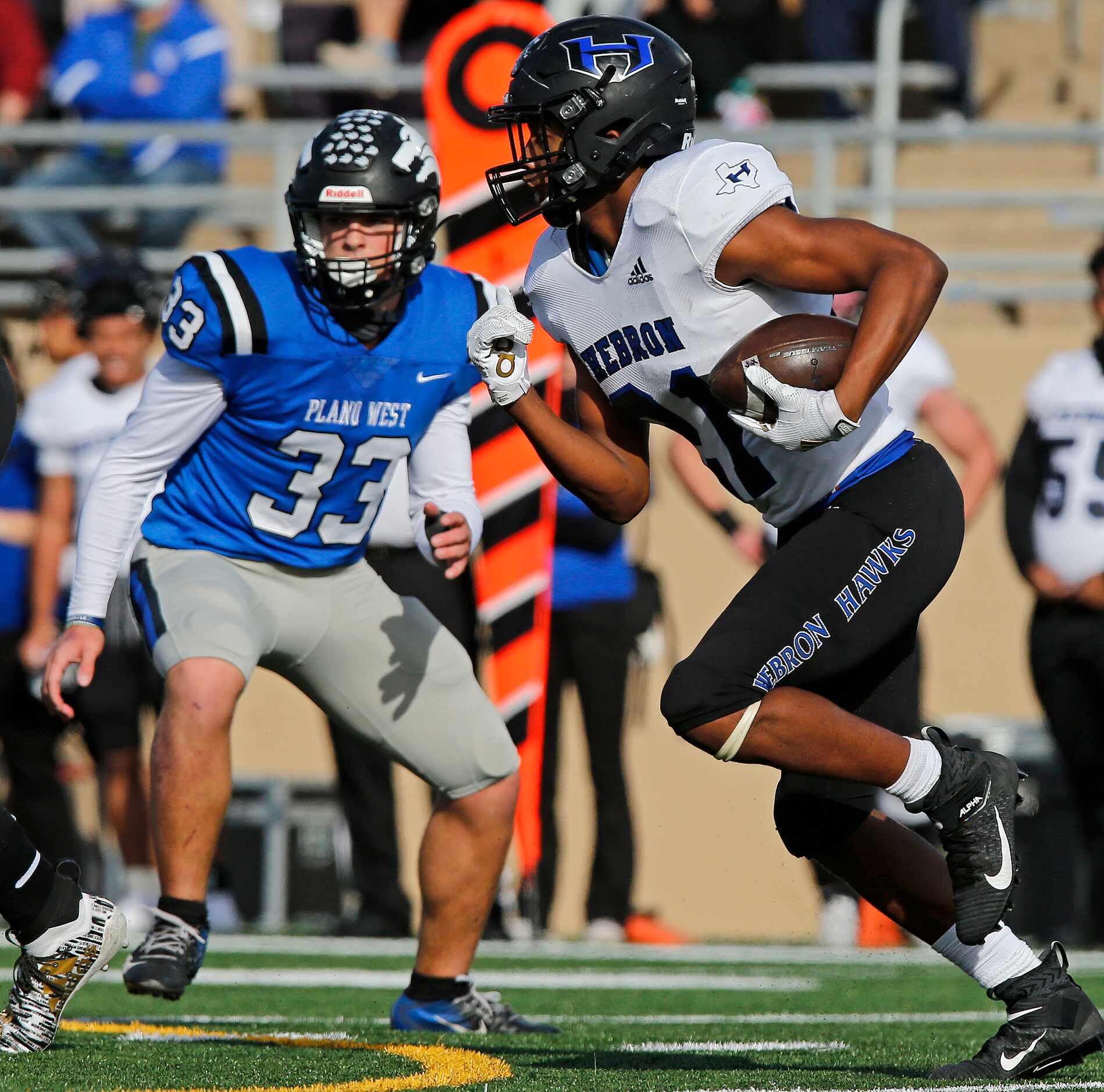 Hebron High School running back Jalon Wilson (21) looks for room to run in front of Plano...