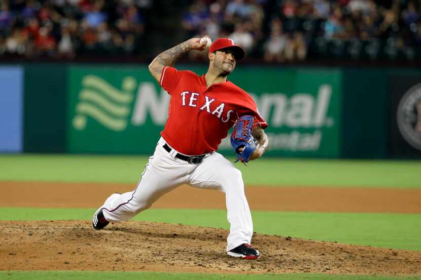 Texas Rangers' Matt Bush throws to the Chicago White Sox in the seventh inning of a baseball...