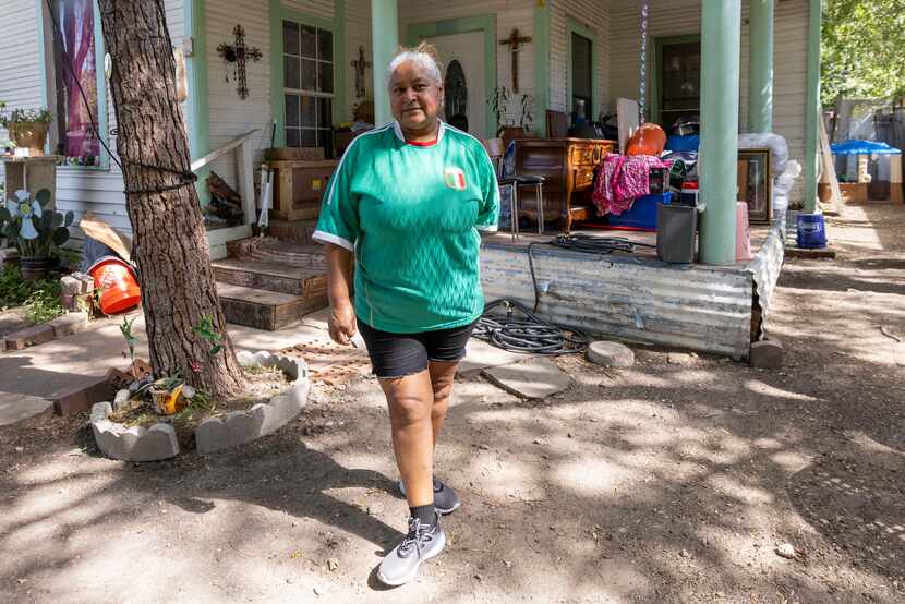 Gloria Alvarez outside her home with furniture and other personal belongings that were...