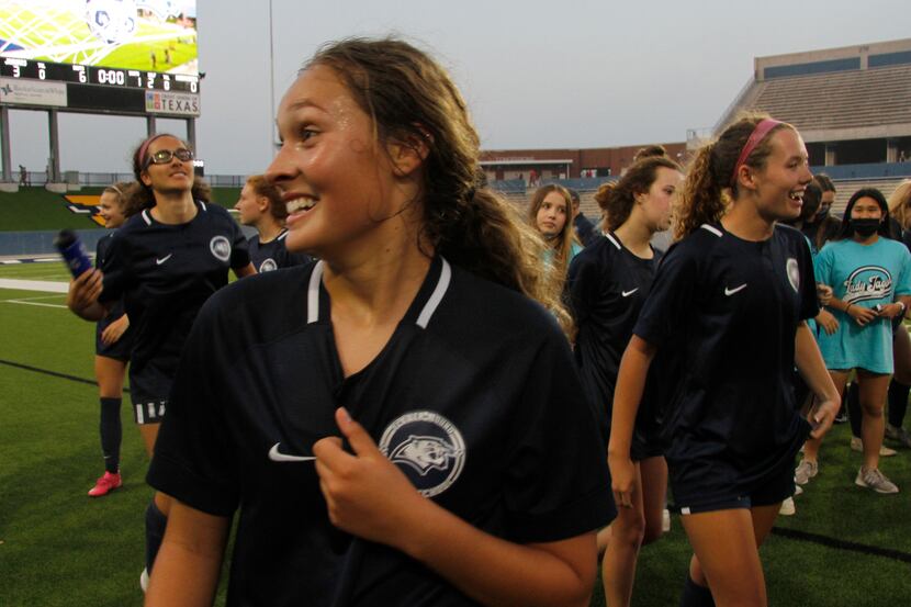 Flower Mound's Sydney Becerra (7) revels in the moment after the team posed for a photo...