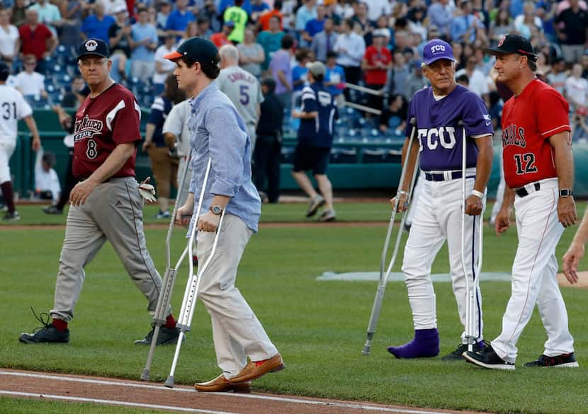 Injured aide Zack Barth (second from left) and injured Rep. Roger Williams, R-Texas, walked...