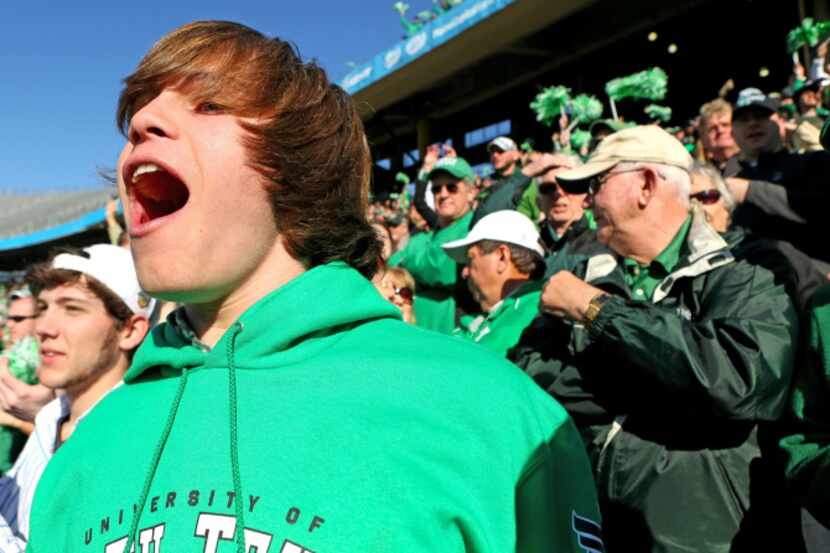 Ian Campbell, 17, cheers for the North Texas Mean Green with his friend Garrett Dawson...