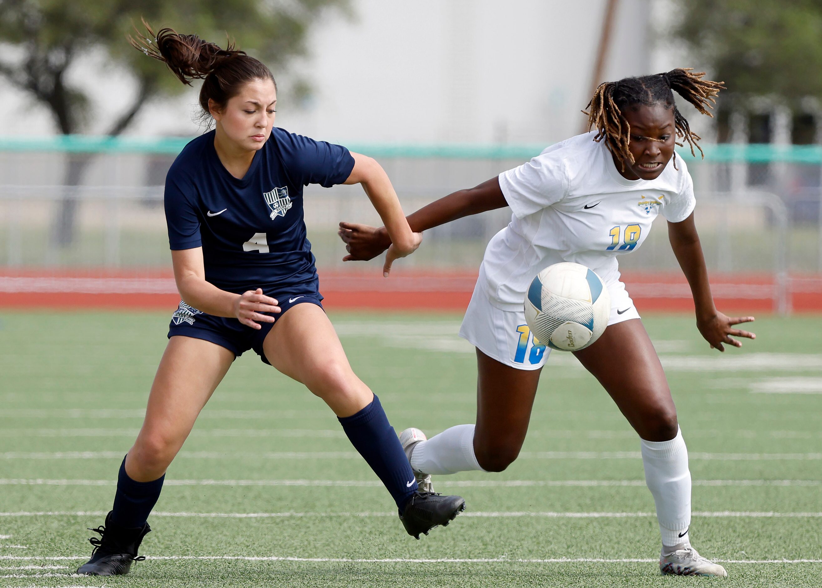 Frisco Reedy’s Naia Rentschler (4) and Frisco’s London Young (18) charge the ball during the...