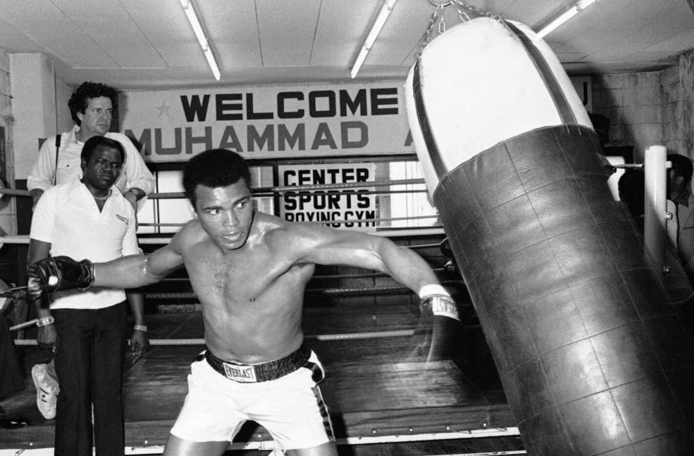 In this Wednesday, June 23, 1976 file photo, Muhammad Ali throws a left punch at a sandbag...