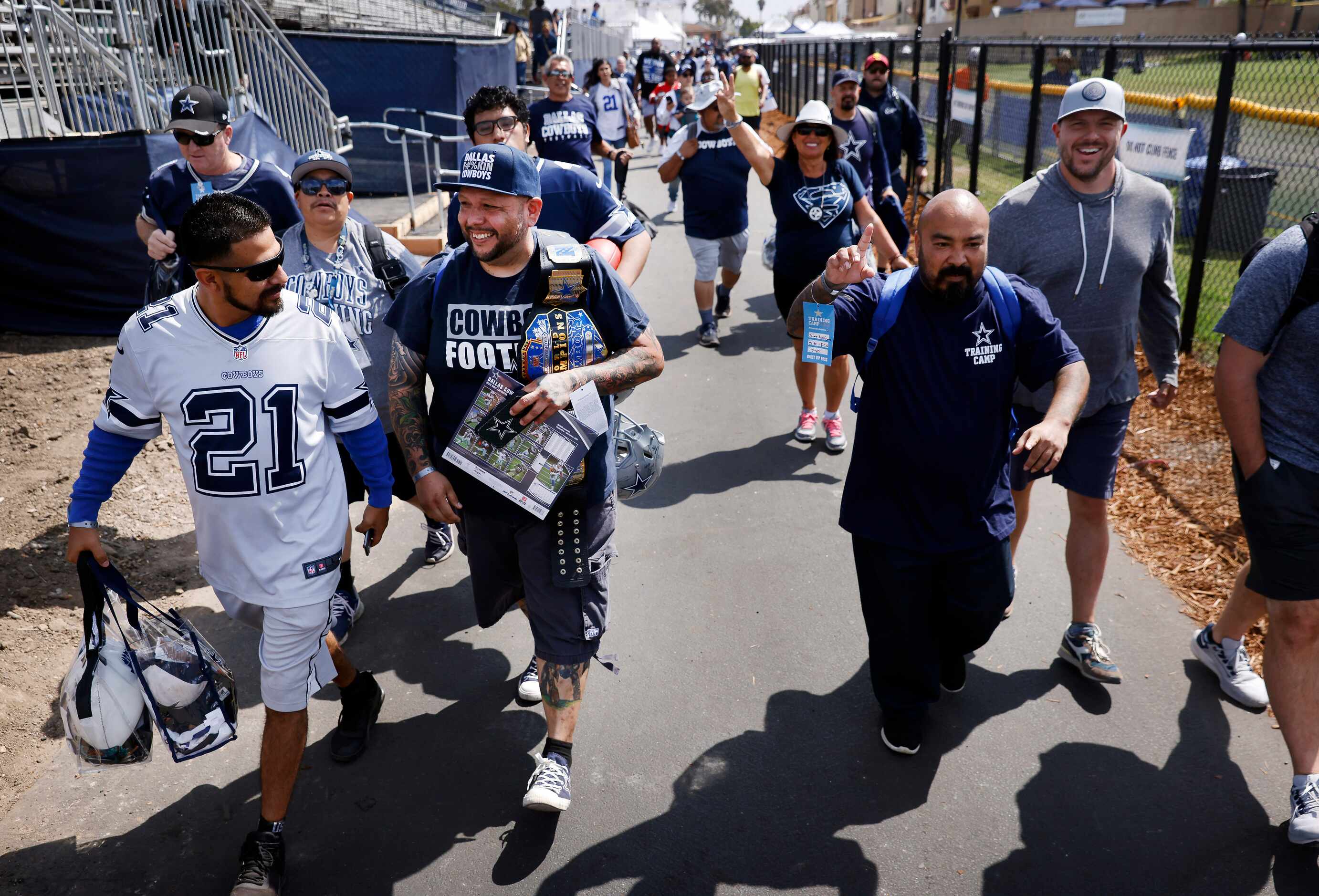 After the gates opened, Dallas Cowboys fans hurry to secure a front row spot to watch the...