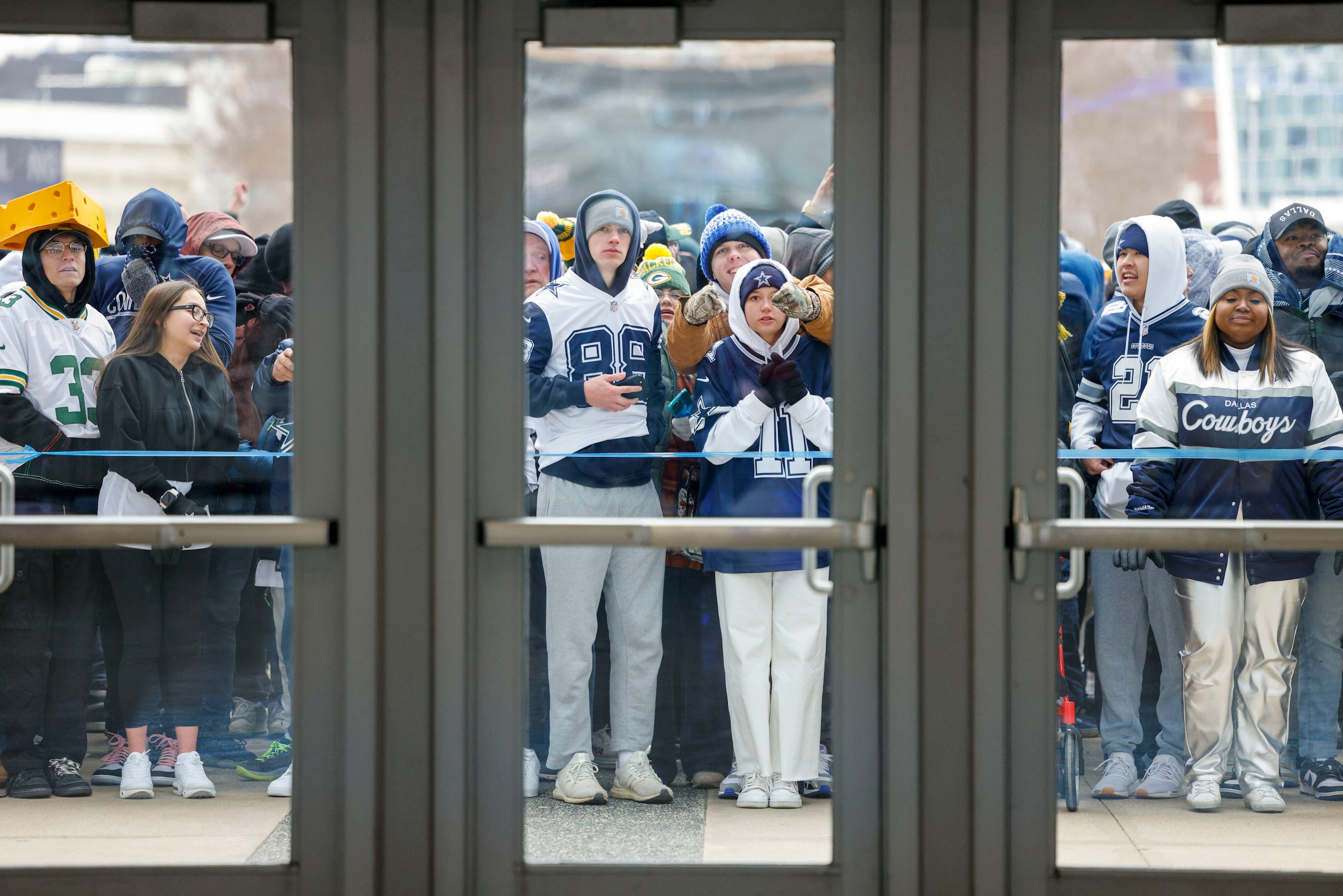 Fans wait for doors to open so they can claim their standing room only spots before an NFL...