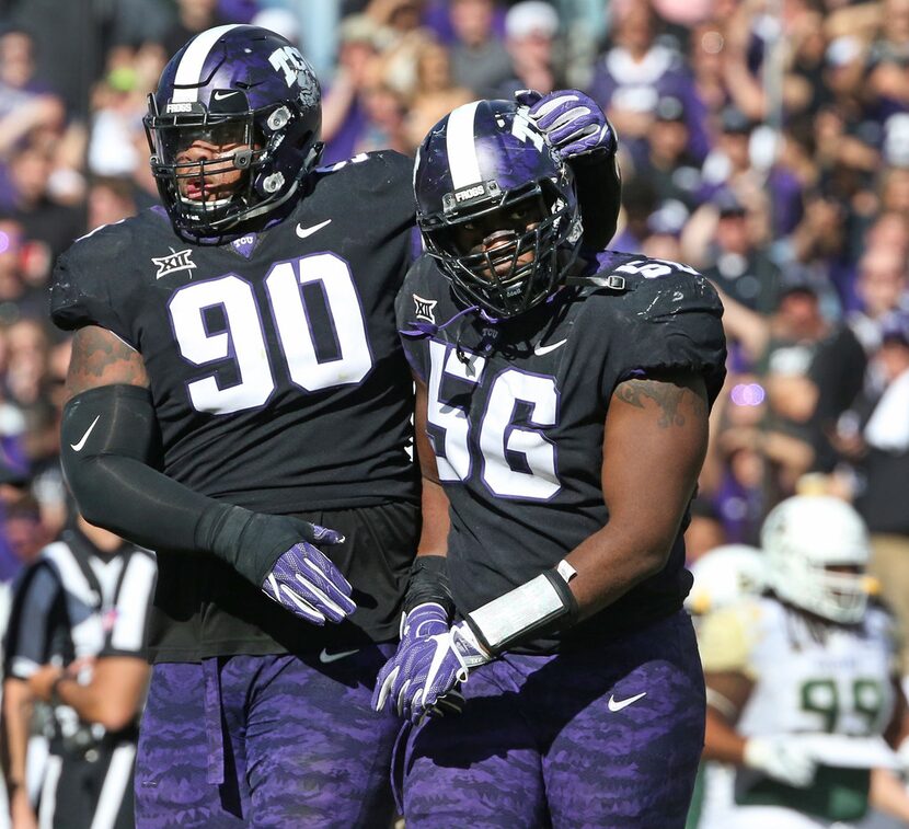 TCU Horned Frogs defensive tackles Ross Blacklock (90) and Chris Bradley (56) walk off the...