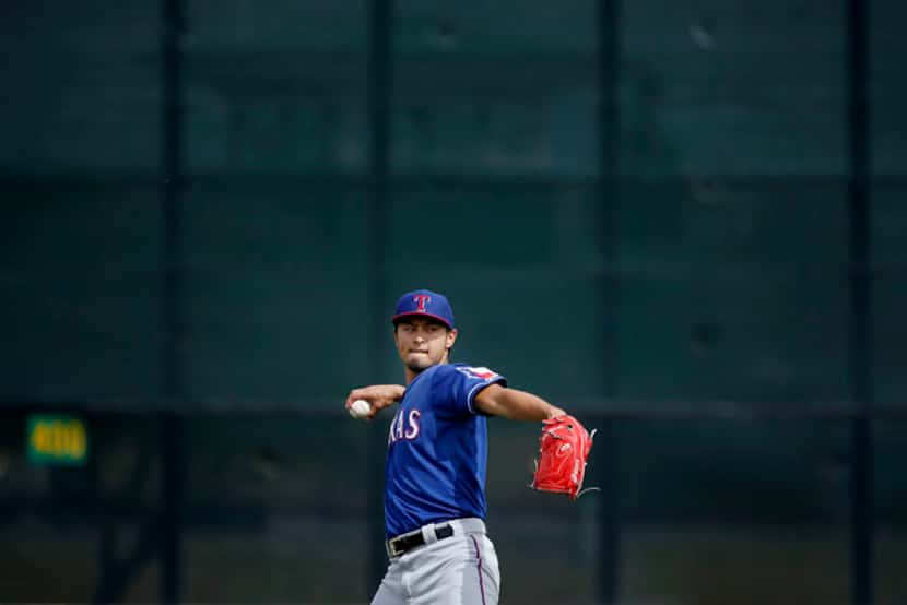  Texas Rangers pitcher Yu Darvish warms up prior to pitching in the team's first intrasquad...