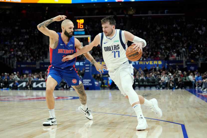 Dallas Mavericks guard Luka Doncic (77) is defended by Detroit Pistons guard Evan Fournier...