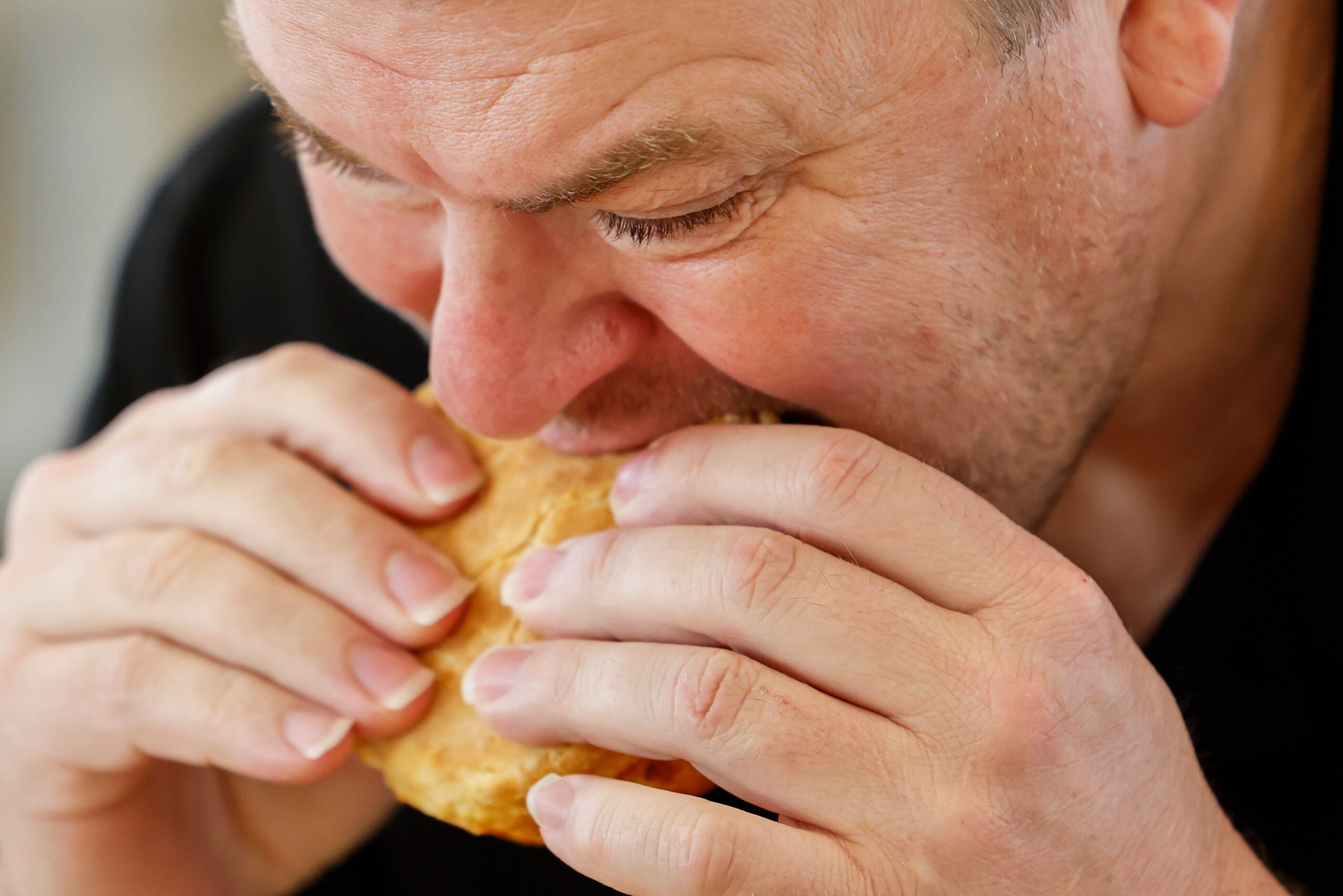 Jason Tucker, general contractor of Bojangles in Euless  takes a bit on his biscuit during...