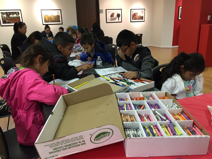 Children color at the Mexican consulate in Dallas, while their parents listen to...
