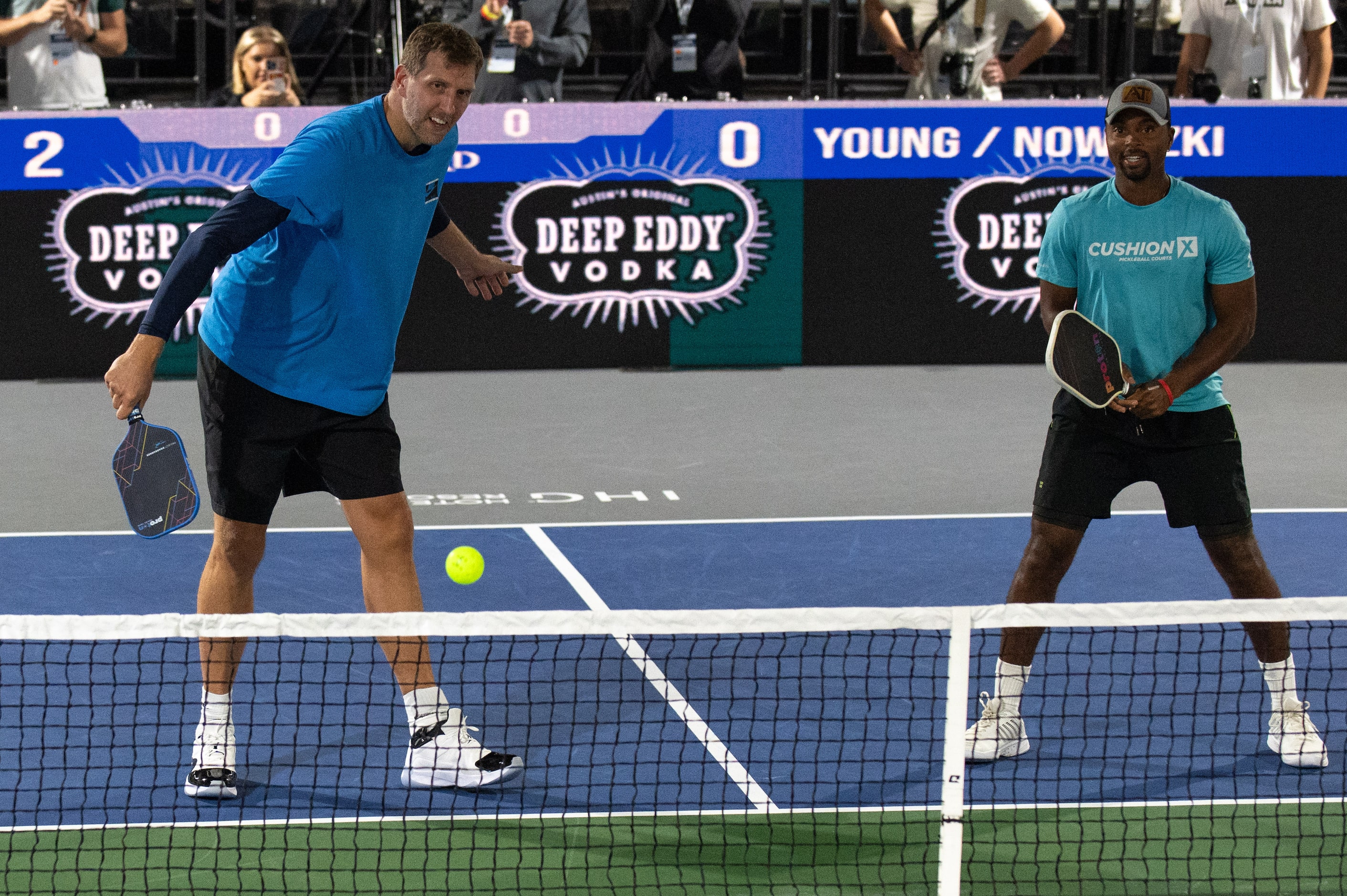 Former Dallas Mavericks center Dirk Nowitzki swings at a ball with pro Pickleball player...