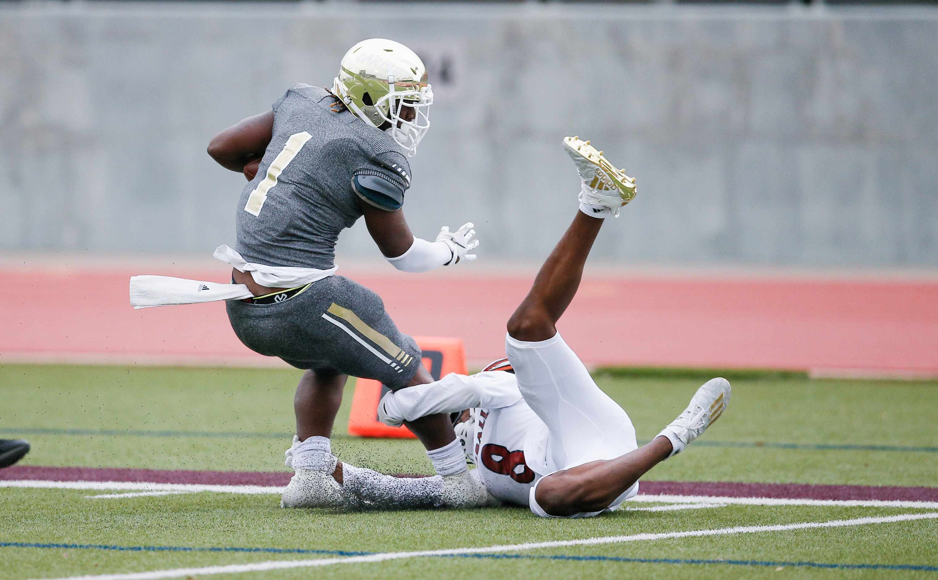 Kimball senior safety Darrius Darensbourg (8) tackles South Oak Cliff senior running back...