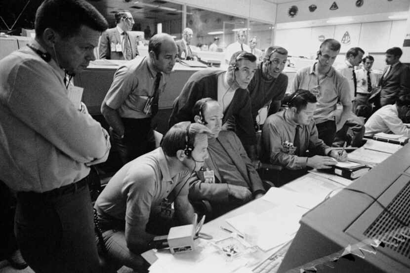 NASA astronauts and flight controllers monitored the problem-plagued Apollo 13 mission from...