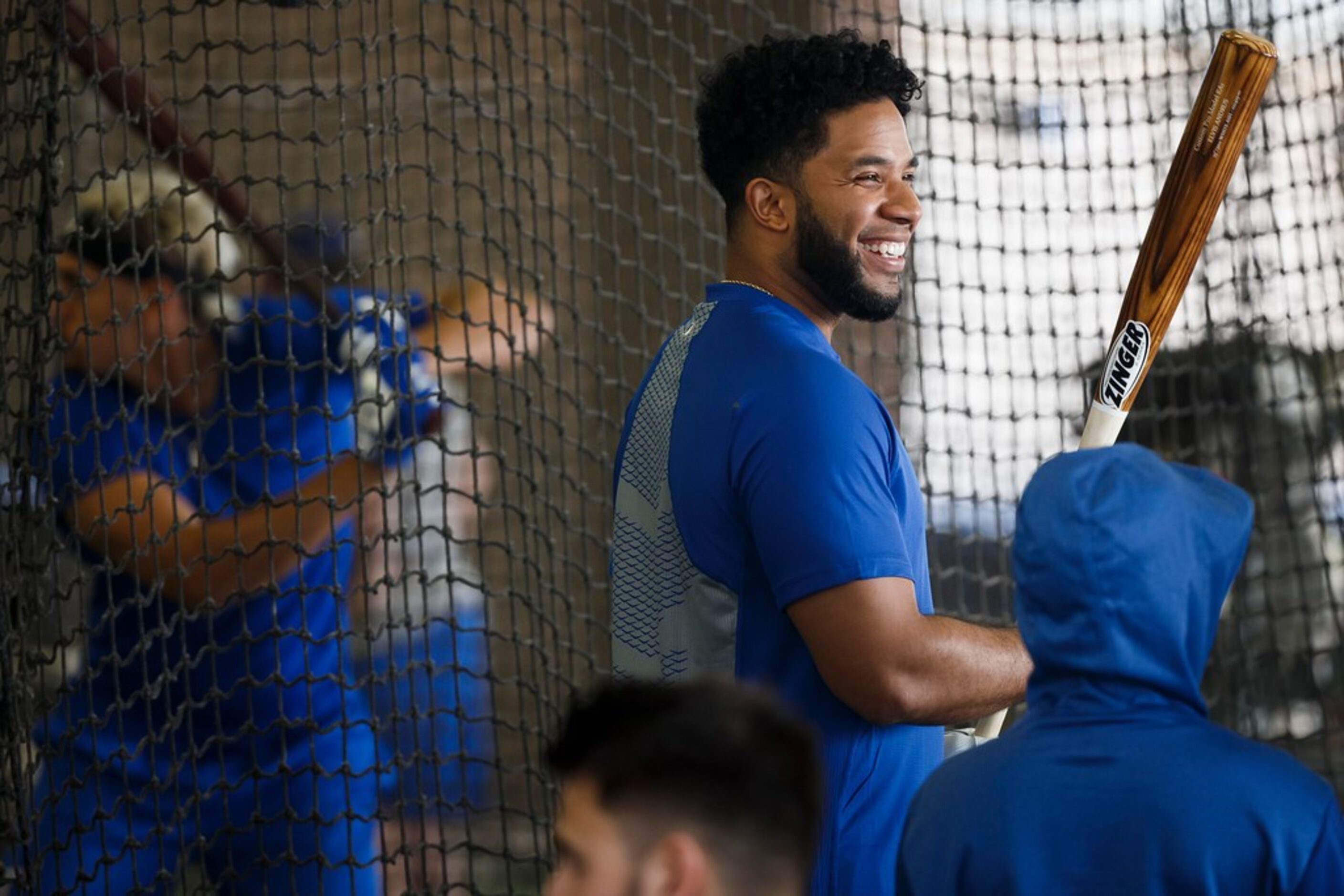 Texas Rangers shortstop Elvis Andrus laughs with teammates in the batting cages during a...