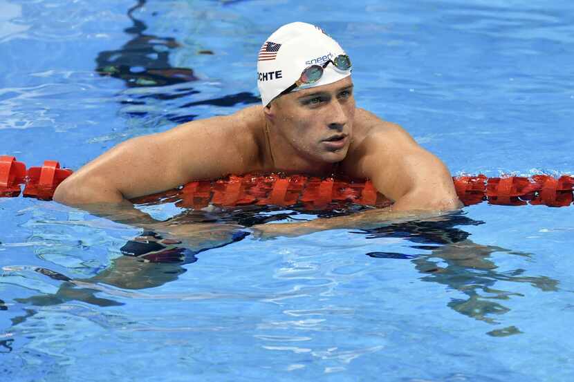 FILE - In this Aug. 9, 2016, file photo, United States' Ryan Lochte checks his time after a...