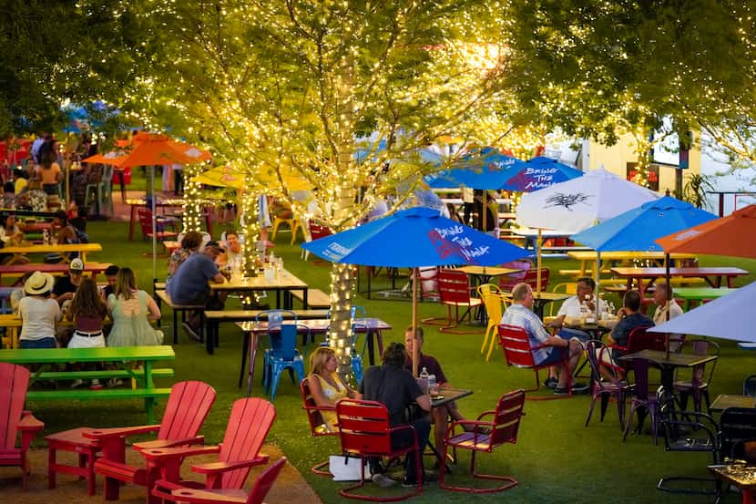 The ArtPark at Trinity Groves has picnic tables, Adirondack chairs and 28 TVs.