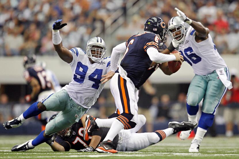 Dallas Cowboys linebacker DeMarcus Ware (94) and defensive end Marcus Spears (96) pressure...