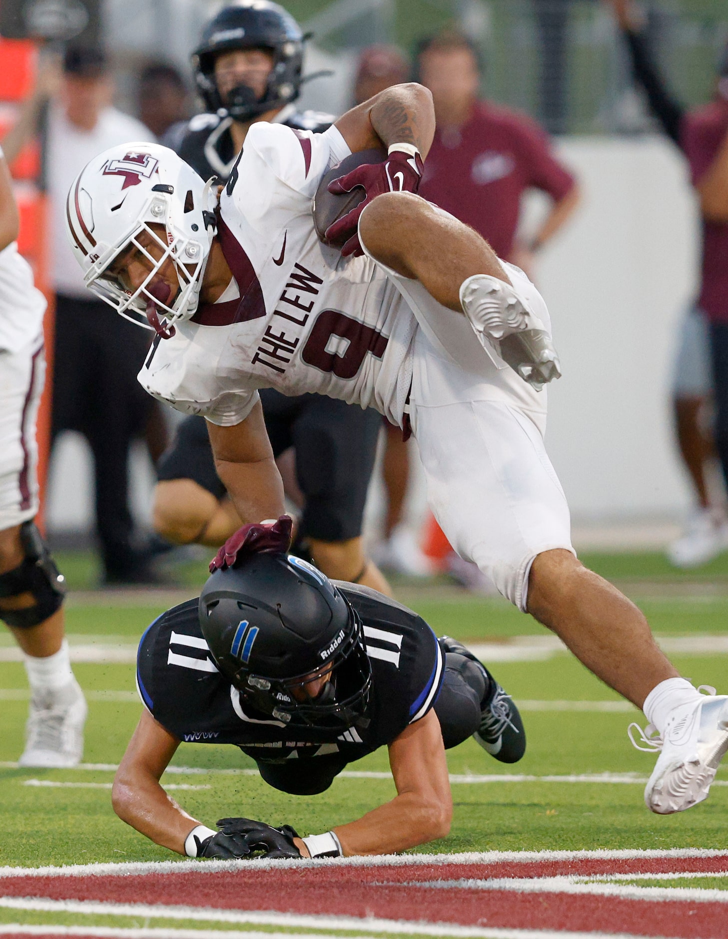 Lewisville's Tenel Hill (9) jumps over Byron Nelson's Leo Almanza (11) during the first half...