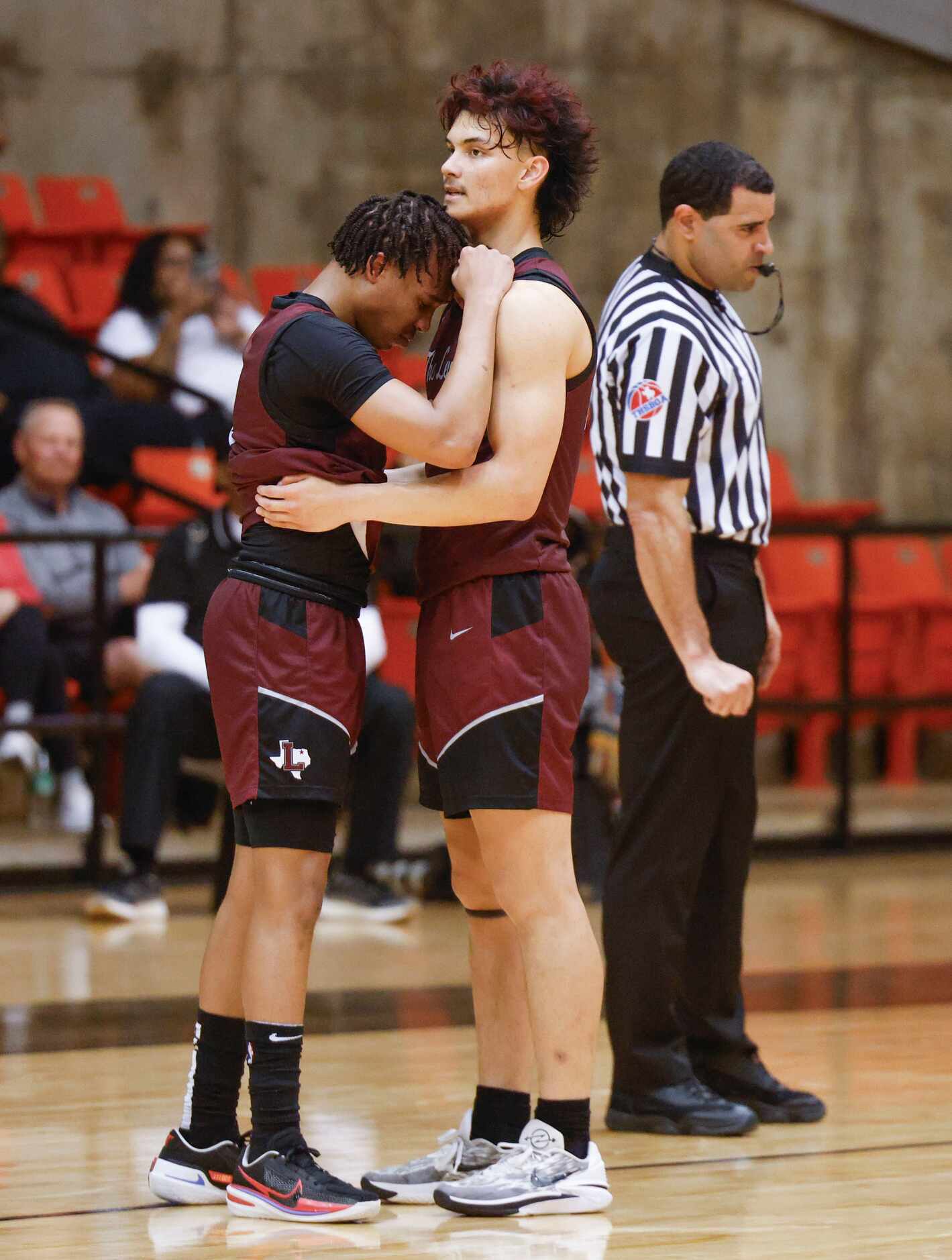 Lewisville High’s Rakai Crawfod (left) gets comforted by his teammate Aj Mcpeters following...