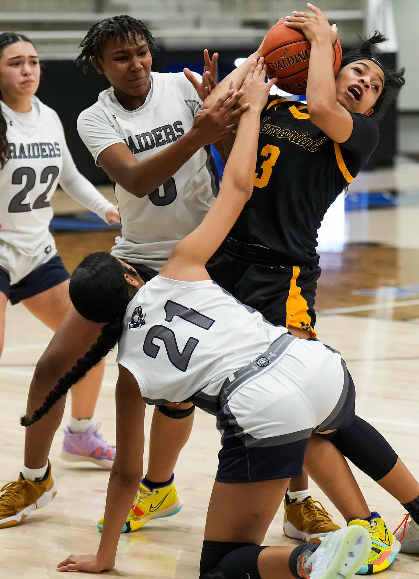 Frisco Memorial's Wynter Jones (3) wrestles a loose ball away from Wylie East's Saliz Ward...